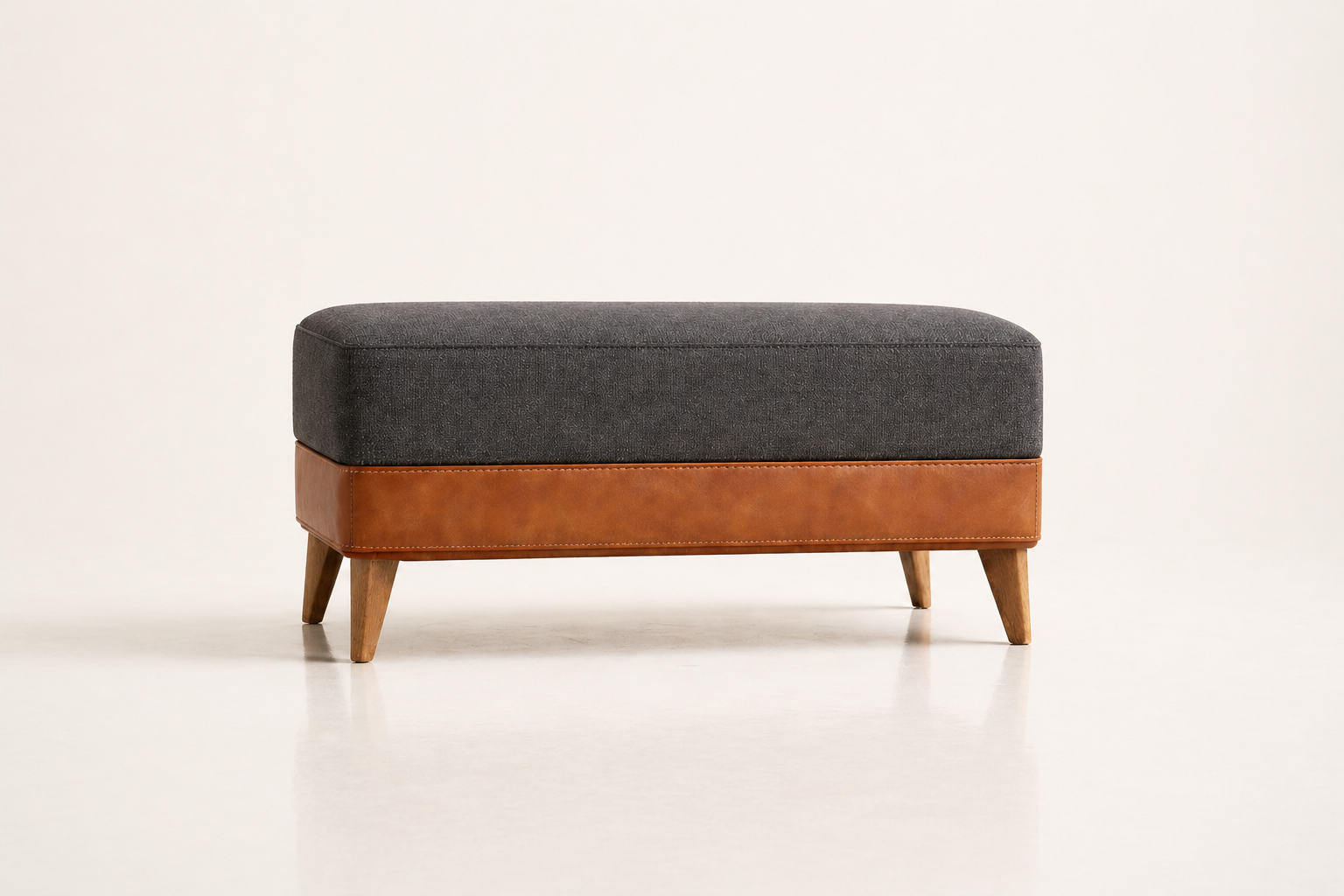 the ANNA ottoman in dark charcoal full-grain leather (BASALT NOIR)