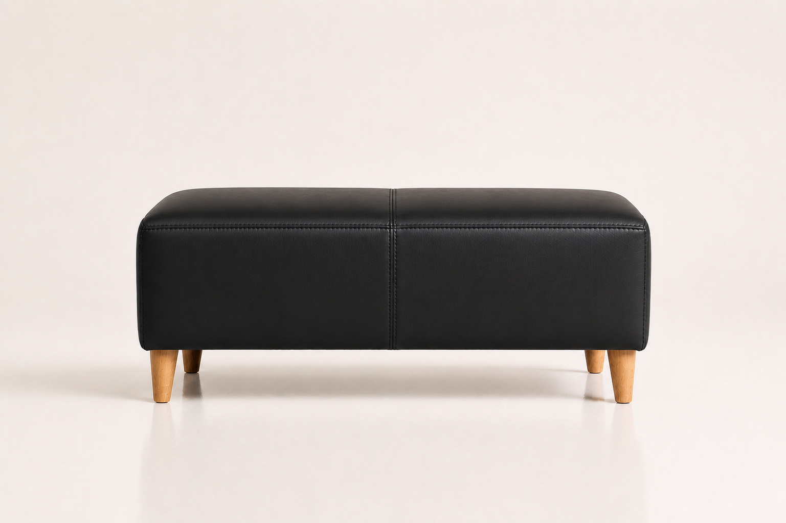 the BETTIE ottoman in black full-grain leather (BLACK RAIN)